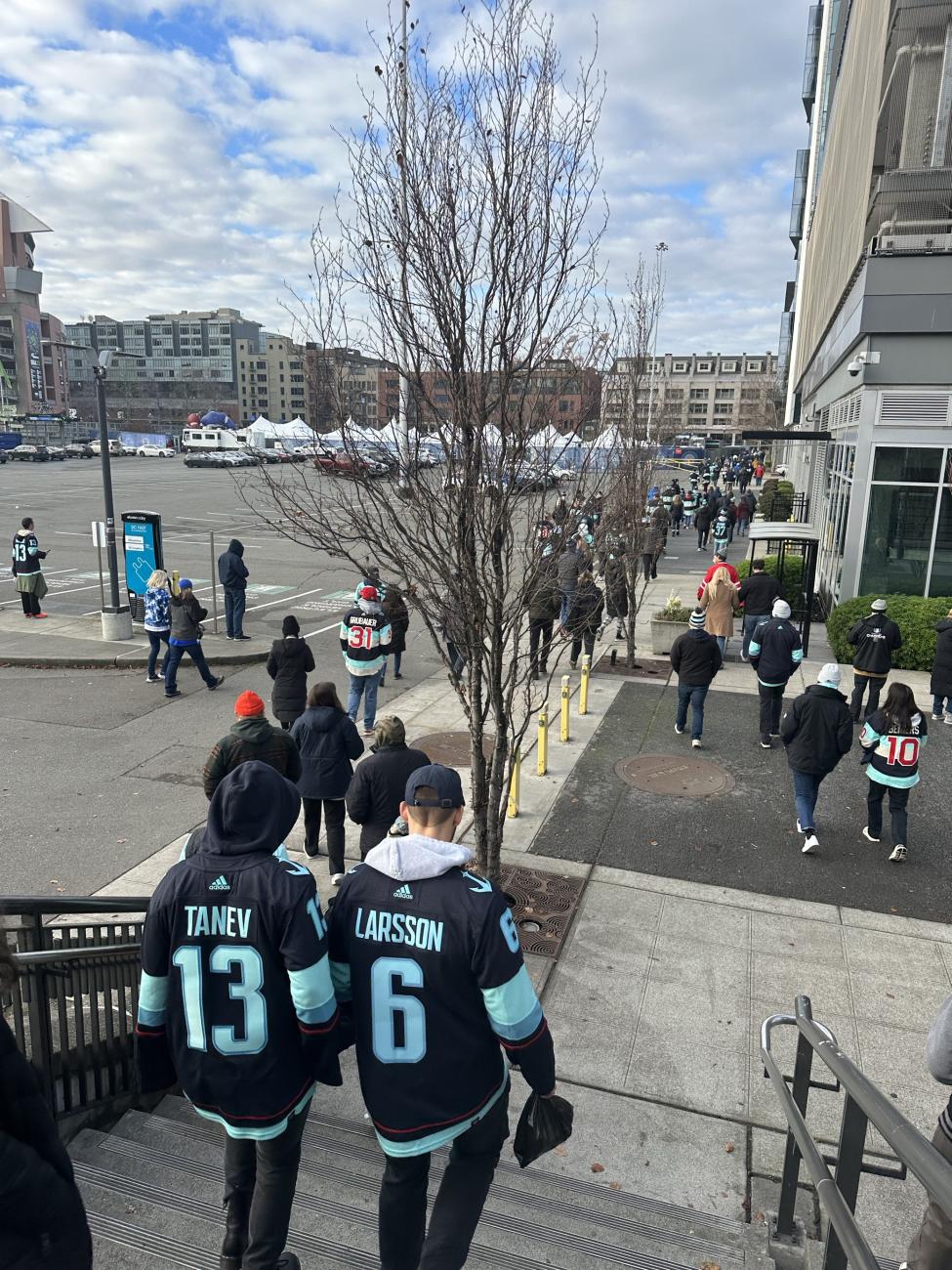 Fans in a Tanev and Larsson jersey walk to the stadium.