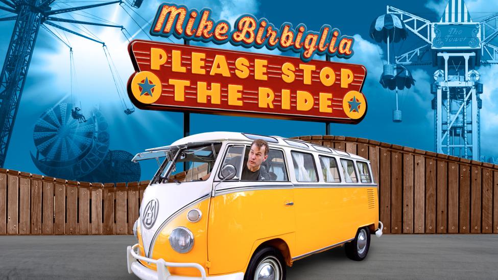 A promotional image for Mike's tour where he rides in a yellow VW van. A sign behind him reads 'Please stop the ride'