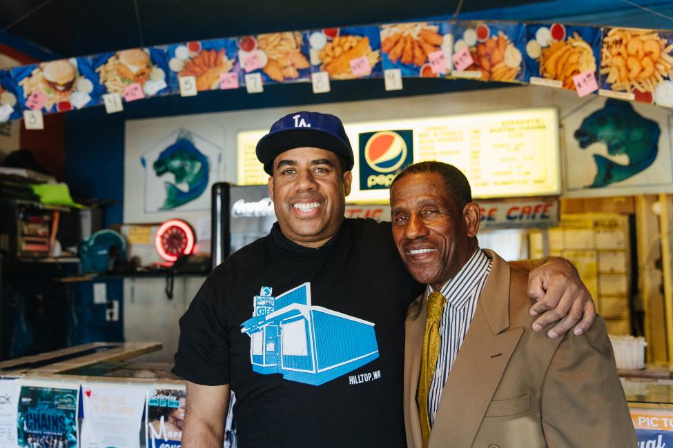 Fish House Cafe owners embrace in front of the counter