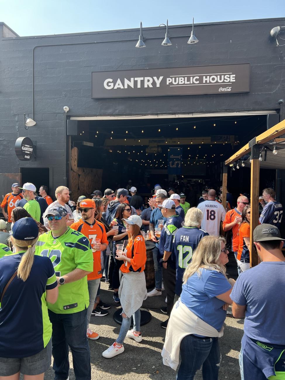 Seahawks fans gather outside Gantry Public House on a sunny day
