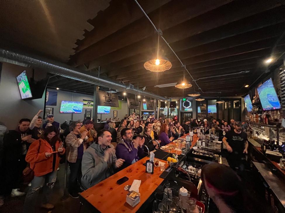 People watch a football game on several tvs at the Westy in Roosevelt