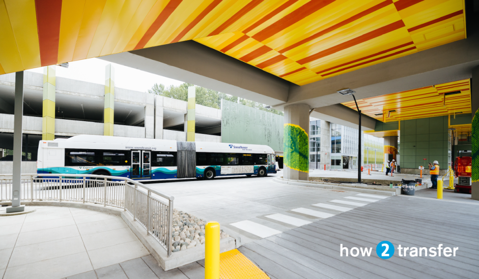 An ST Express bus drives next to the new South Bellevue Link station