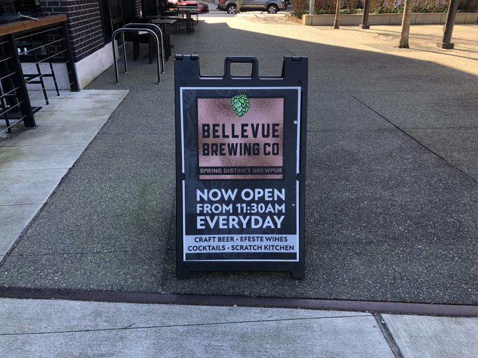 An A-Board featuring the Bellevue Brewing Company noting they are open 11:30 A.M everyday.