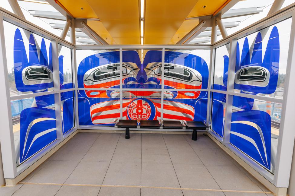 Vibrant glass panels by local Indigenous artist Preston Singletary on the Lynnwood City Center Station platform.