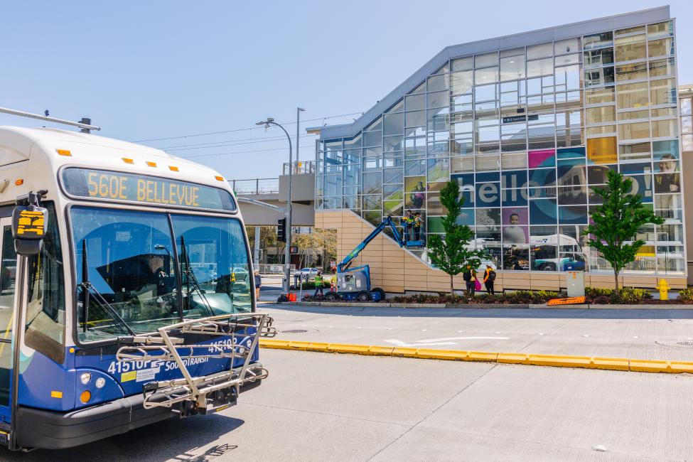 An ST Express bus with a 2 Line station in the background