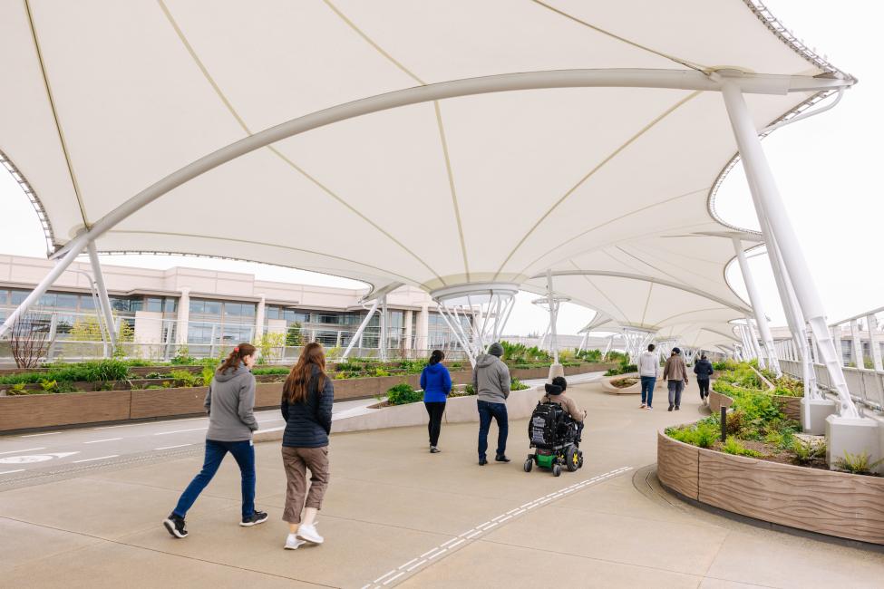 People walk across the new bridge by Redmond Technology Center