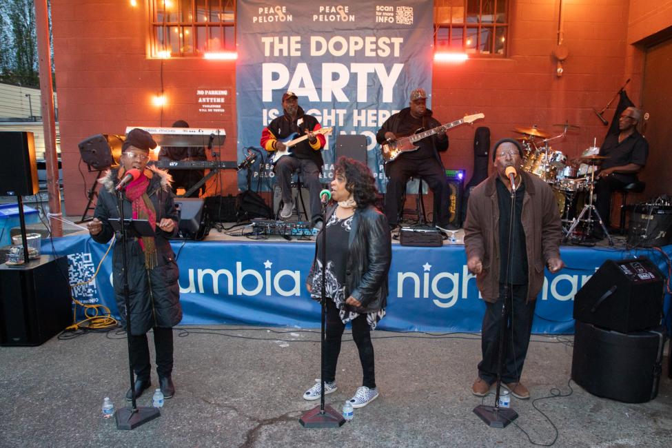 A trio of performers sing at the Columbia City Night Market