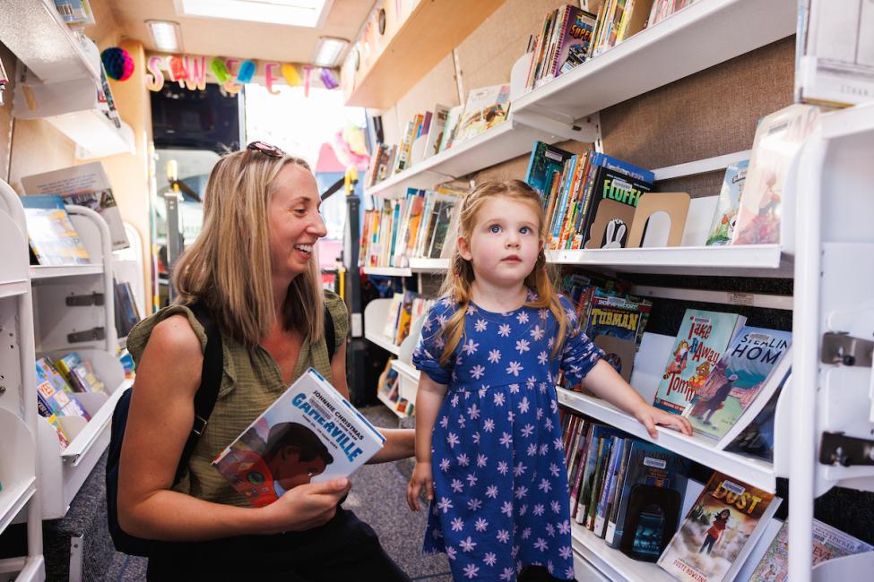 A parent and child explores the mobile library provided by Sno-Isle