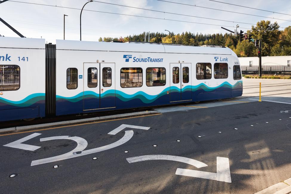 The first car of a Link light rail train in at grade section of track in Bellevue
