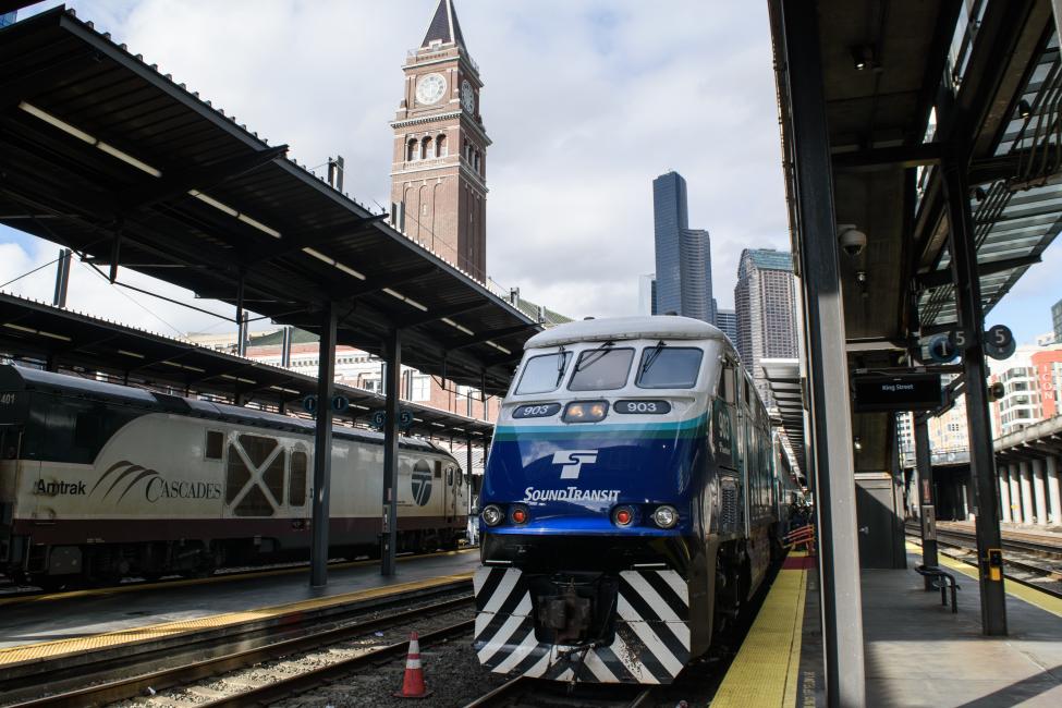 A Sounder train in the foreground with an Amtrak train in the background at King Street Station in Seattle