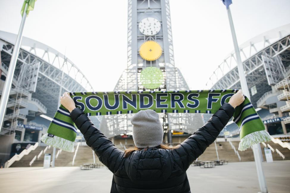 Person holding Sounders FC scarf
