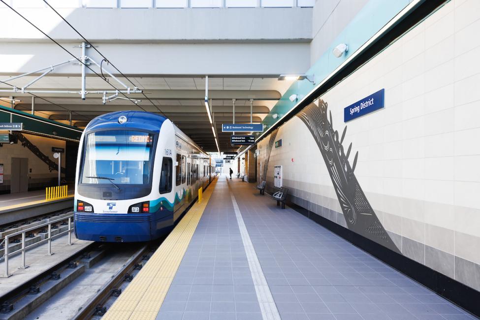 A Link train pulls into Spring District Station