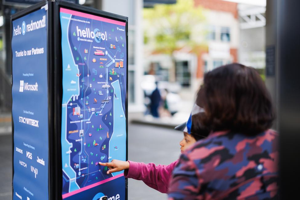 A passenger touches a map highlighting the two new stations
