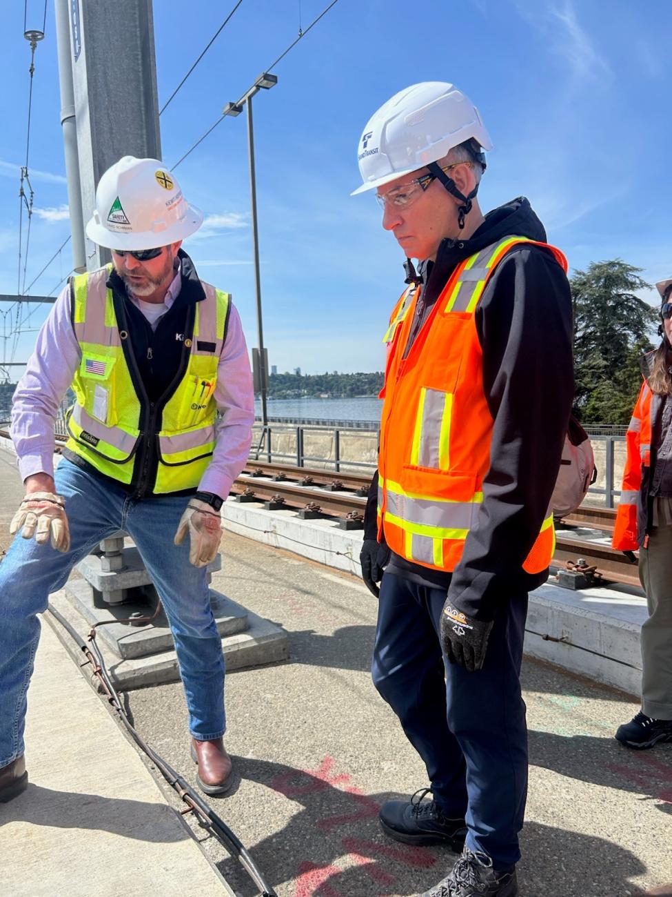 PHOTO CAPTION:   During a tour of the I-90 East Link segment on May 9, Sound Transit CEO Dow Constantine (right) and Kiewit-Hoffman Project Manager David Bowman discussed the unique design of the concrete structures that support the rails and the special methods used to adhere them to the floating bridge. 