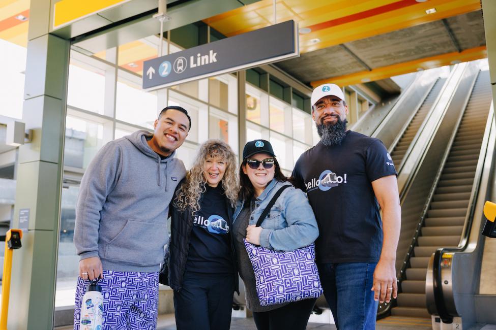 Four people wear merchandise from ST Shop at Downtown Redmond Station