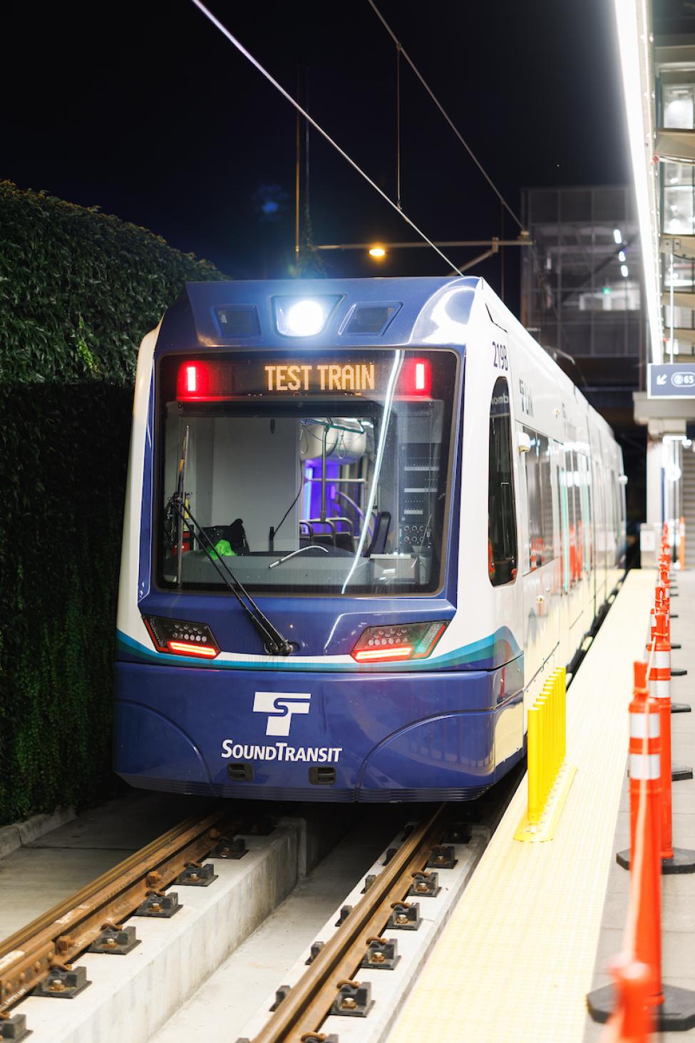 A Link vehicle parked at a platform. The head sign reads "test train."