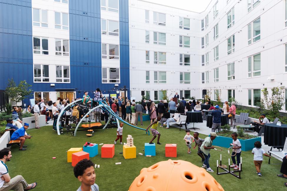 A large group of people in the interior open area of a mixed-use development