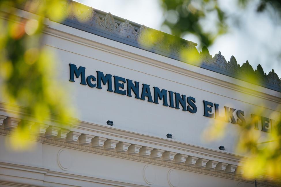 A shot of the McMenamins Elk Lodge with leaves in the foreground