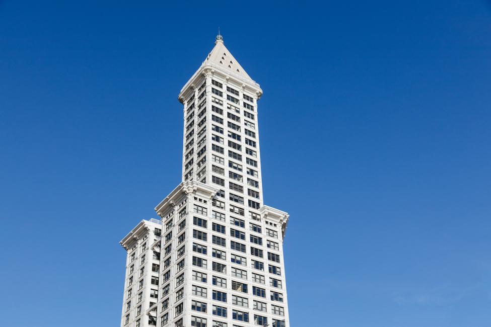 A shot of Smith Tower from street level with a clear, blue sky.