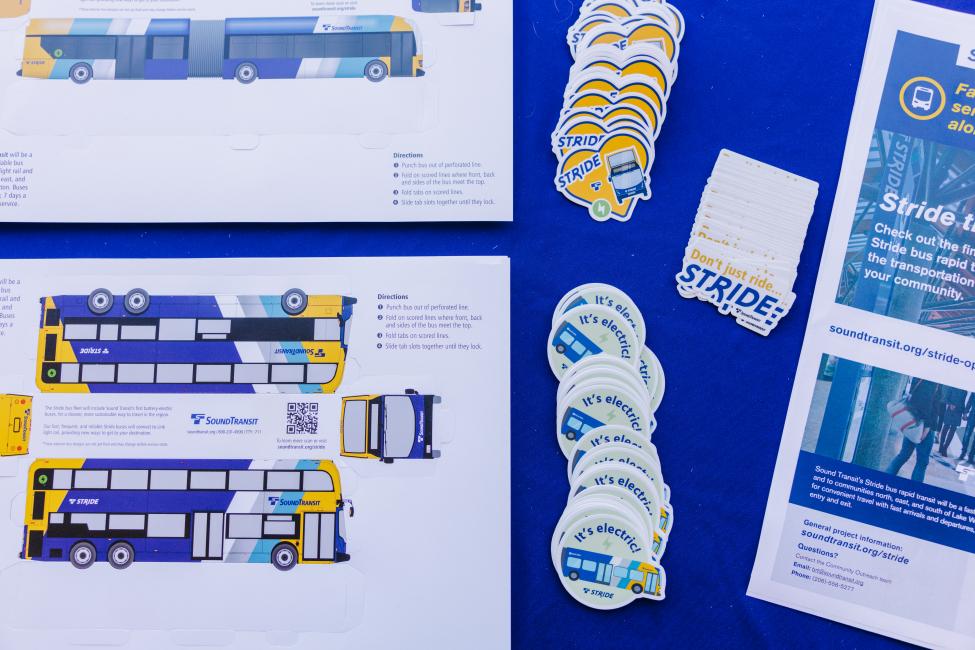Stride bus stickers and fact sheets on a blue tablecloth