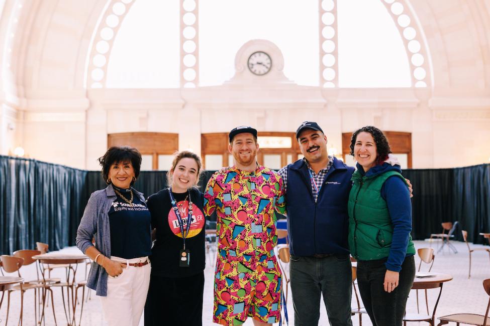 Five Sound Transit employees smile at the camera in Union Station.