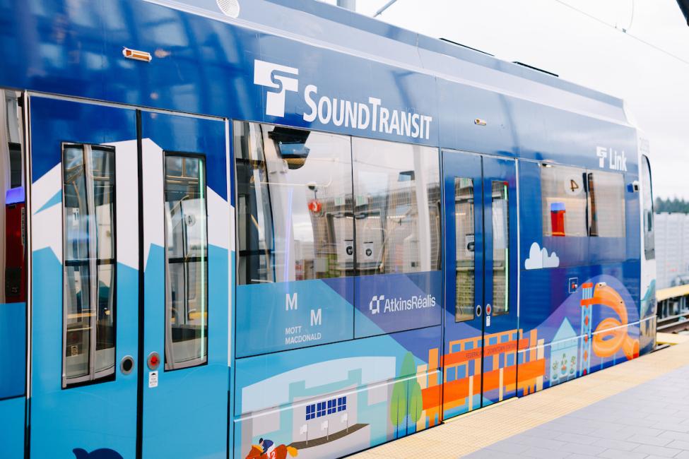 A wrapped link light rail train featuring event themed designs from the Federal Way opening