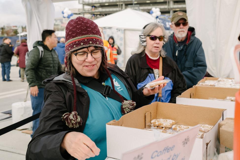 A ST staff member fills boxes with giveaways and goods for passengers.