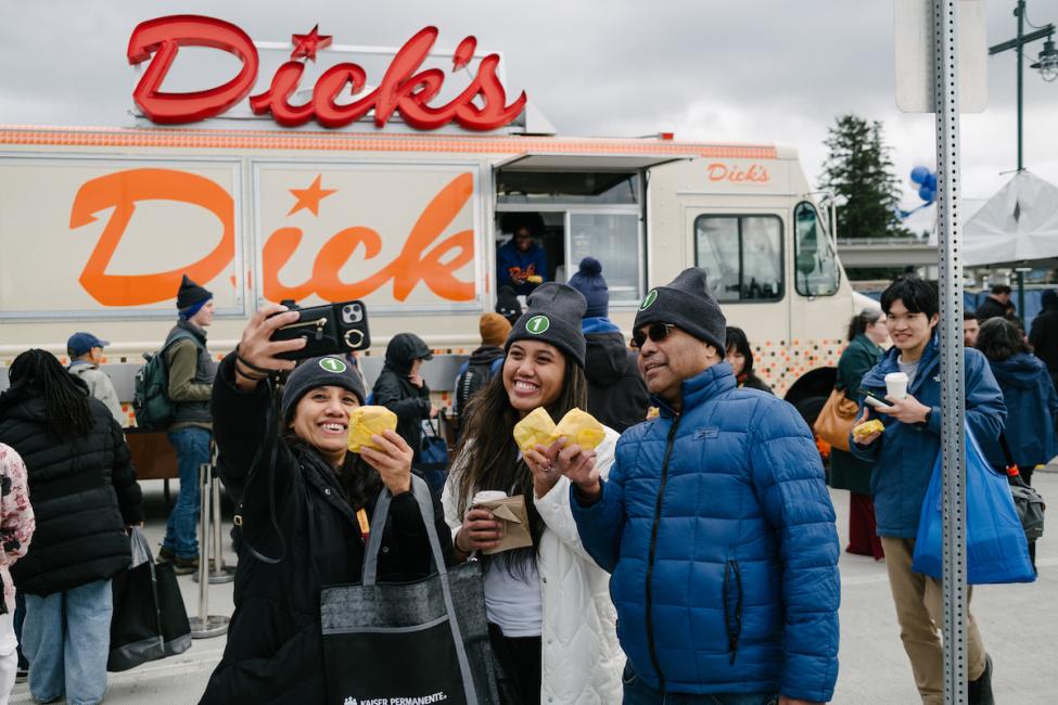 Four people take a selfie by a Dick's Drive In food truck