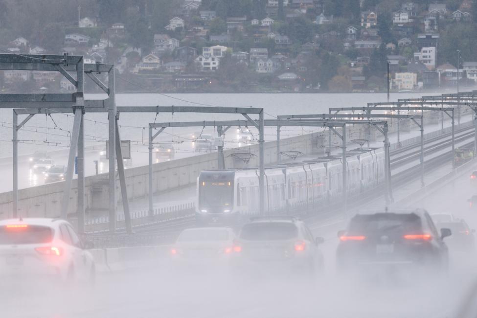 A Link train runs on the I-90 bridge in the morning rain