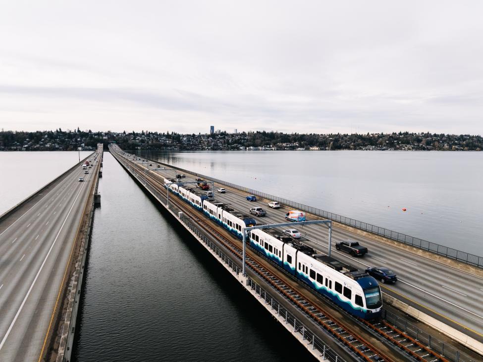 A Link light rail train travels across the I-90 Bridge.
