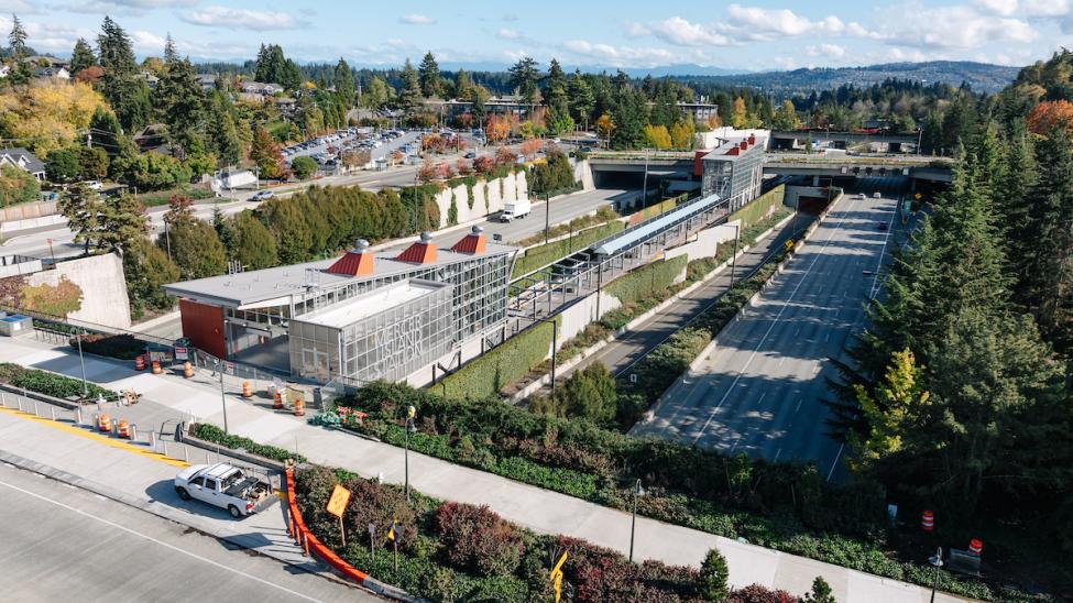 An aerial view of Mercer Island's light rail station, which is situated in the middle of I-90 with two large headhouses. 