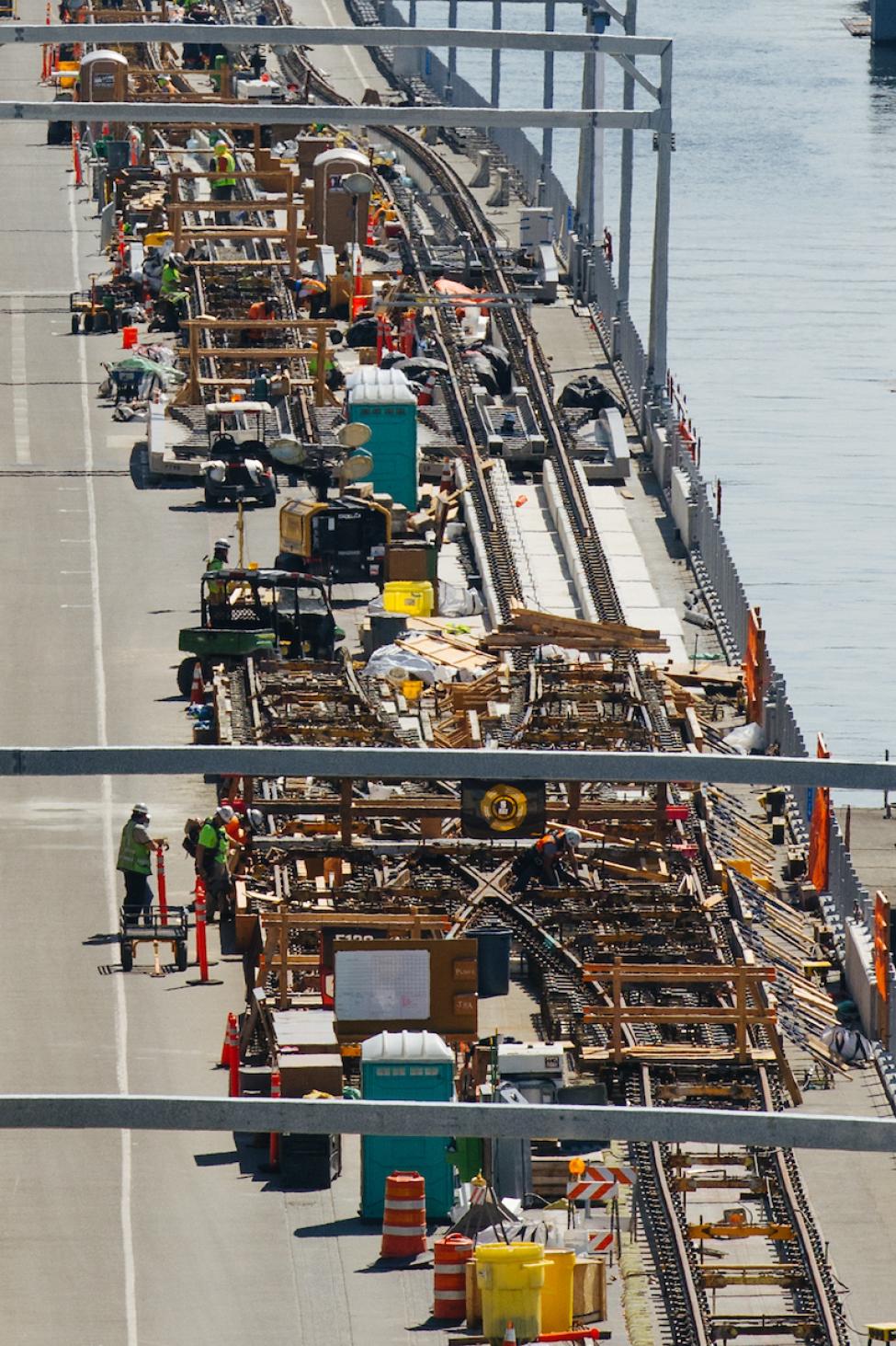 Lots of construction workers and activity as light rail starts construction on the floating bridge