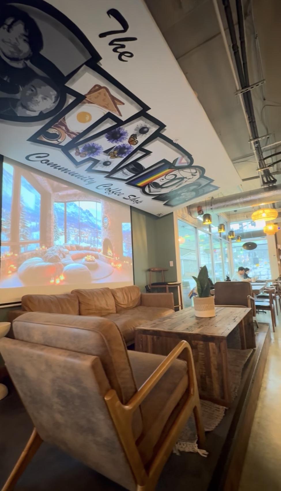 Letter mural art on the ceiling of a coffee shop reads "The Station"