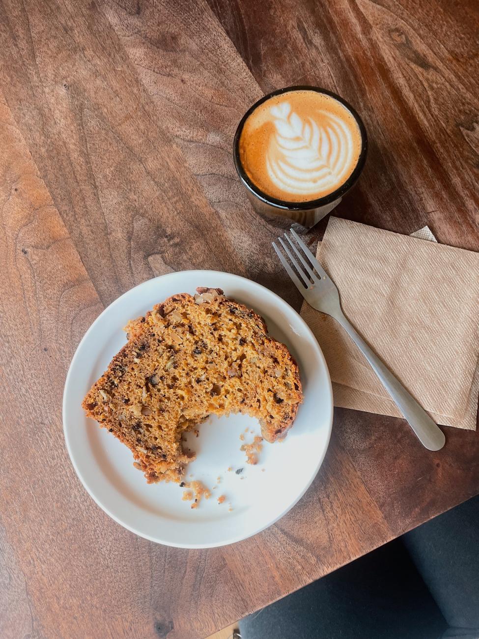 A latte and pastry on a table