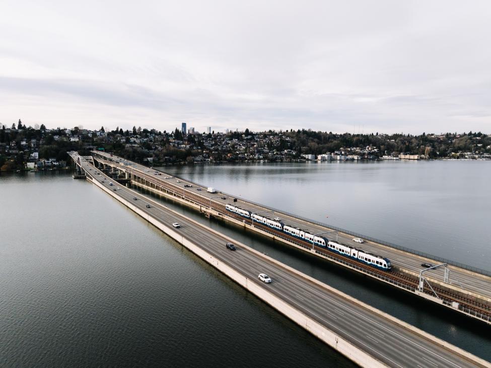 A four-car train crosses the I-90 floating bridge