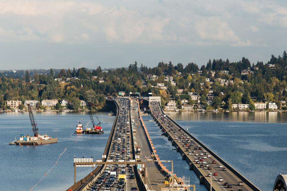 Looking over Lake Washington and the floating bridge toward Mercer Island and the Eastside while construction takes place in the center lanes