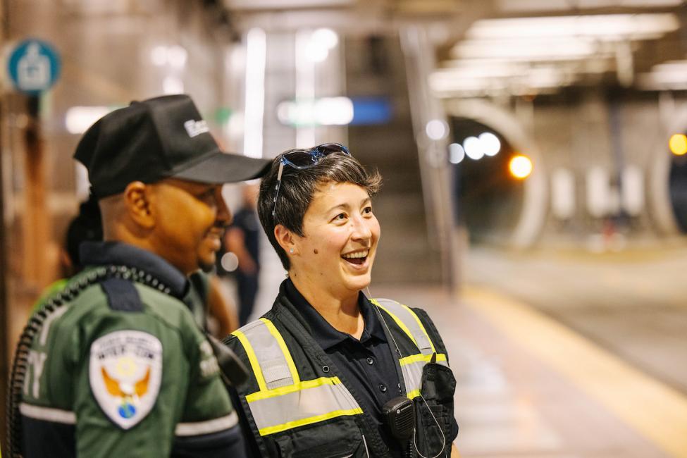 Two members of the Sound Transit public safety team on the platform at a station in the downtown Seattle tunnel