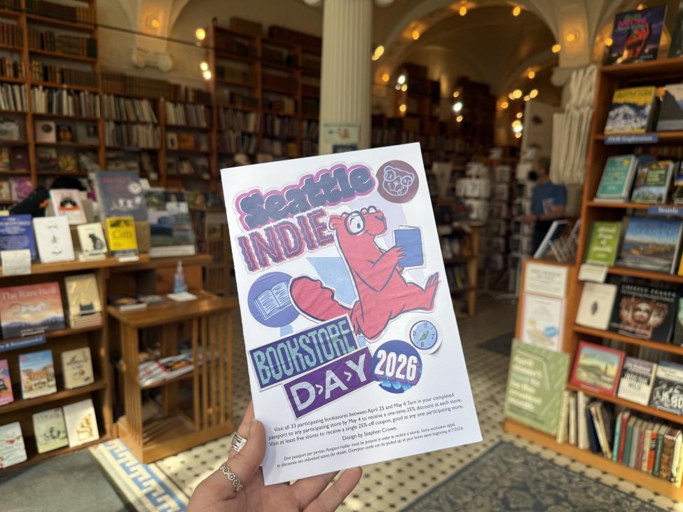 The cover of the passport for Seattle Independent Bookstore Day 2026 features a cartoon animal reading a blue book