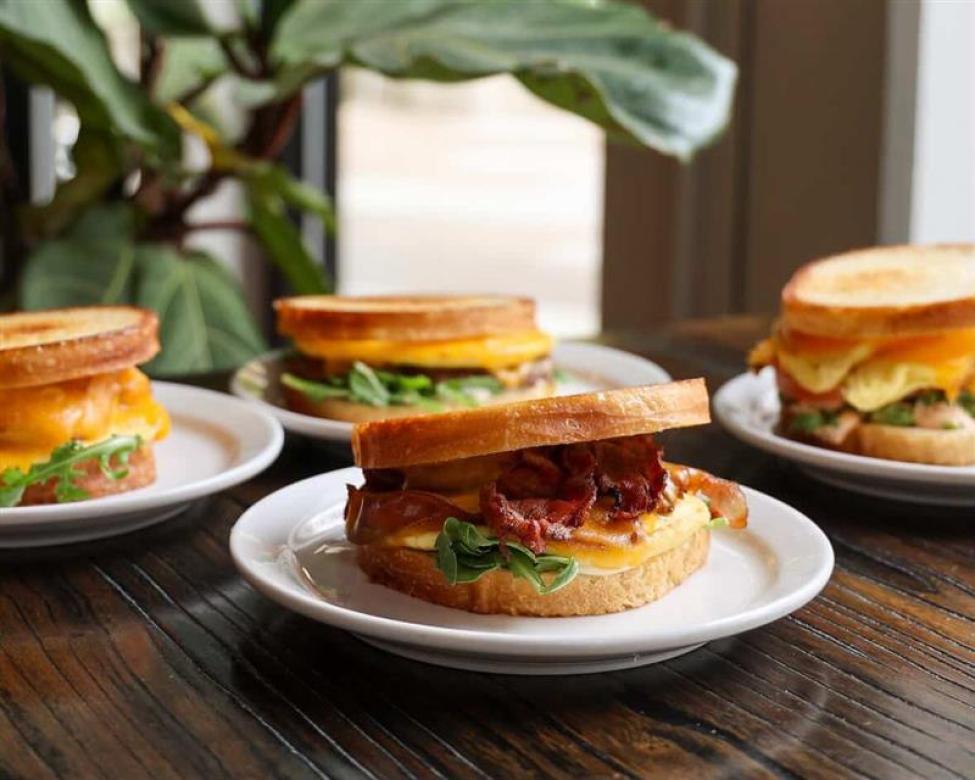 A table with three breakfast sandwiches 