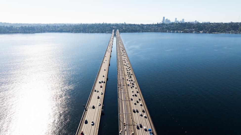 An overhead photo of the bridge across Lake Washington with both the highway and Link track in view.
