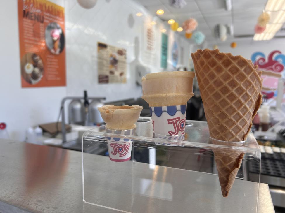 3 types of ice cream cones are presented on a counter