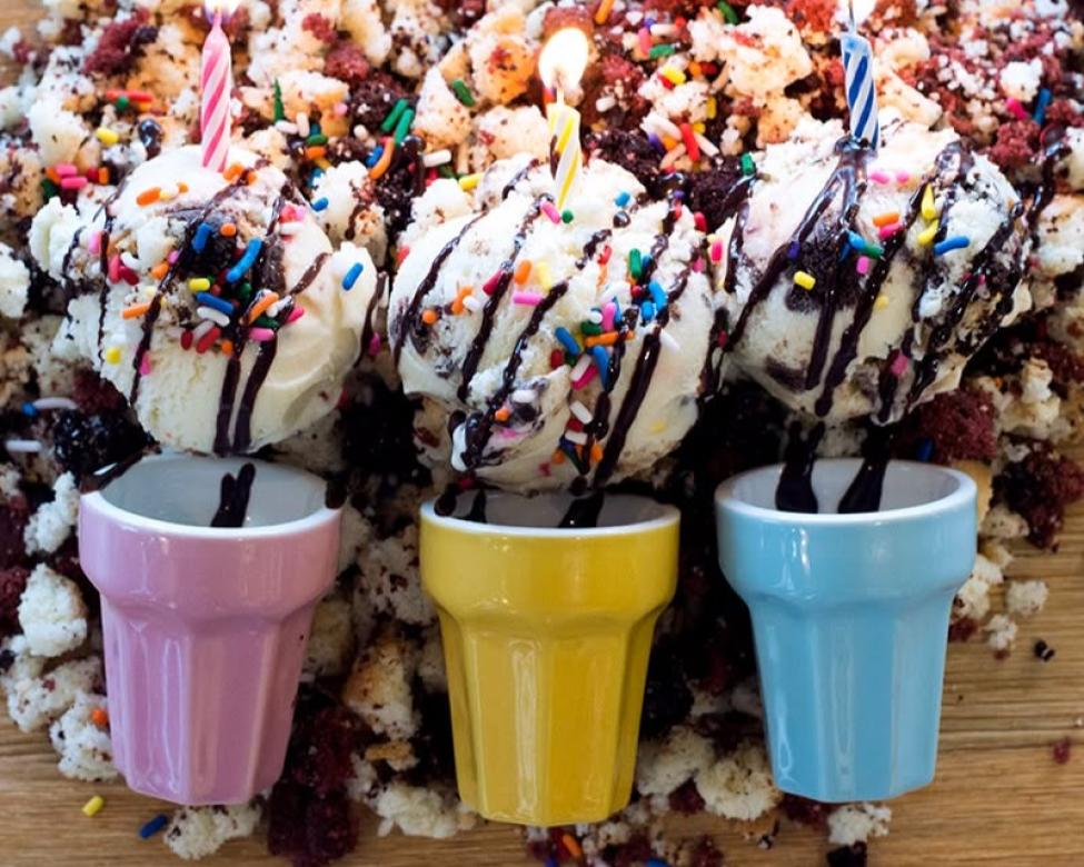 3 scoops of ice cream with chocolate drizzle and sprinkles