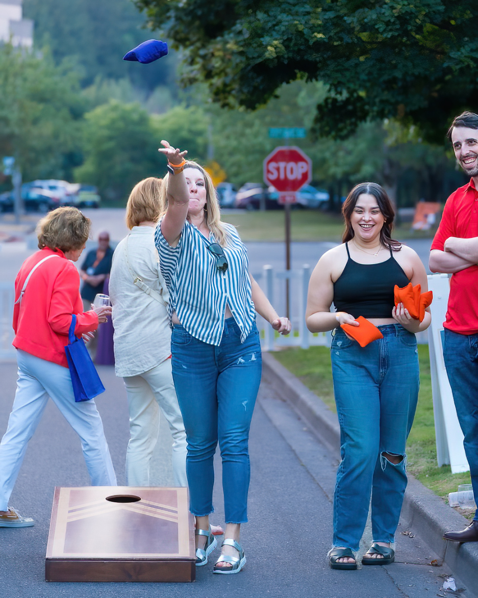 A group of people playing cornhole at Mercer Island's Art Festival