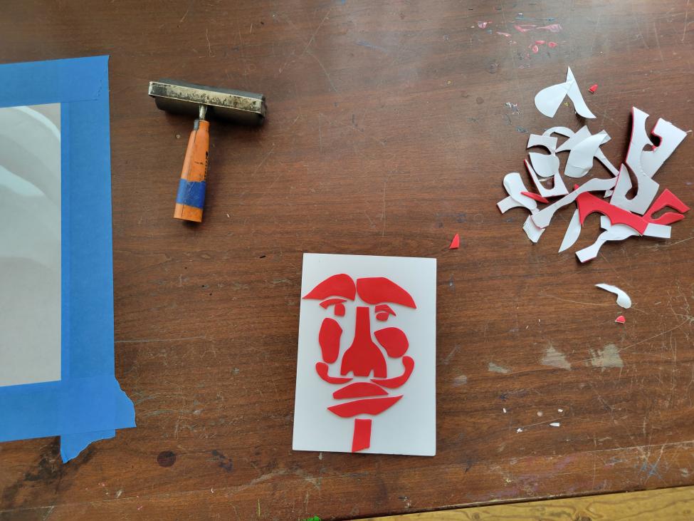 Various tools on a wood table that are used to create art
