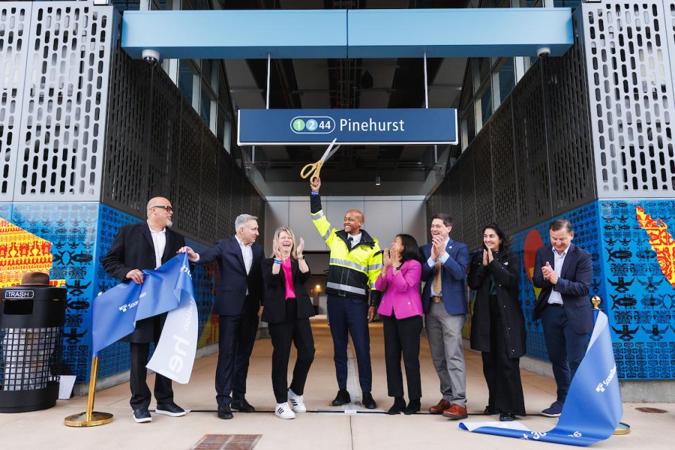 A group of board members, electeds and Sound Transit staff cut the Pinehurst ribbon