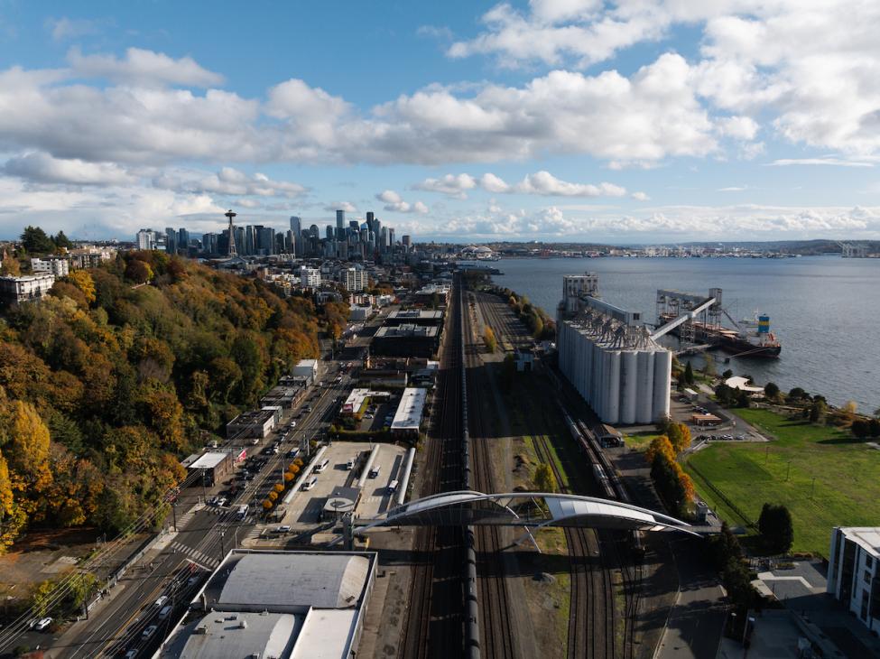 An aerial view of the Interbay area of Seattle, with Elliott Bay on the right and downtown in the distant left