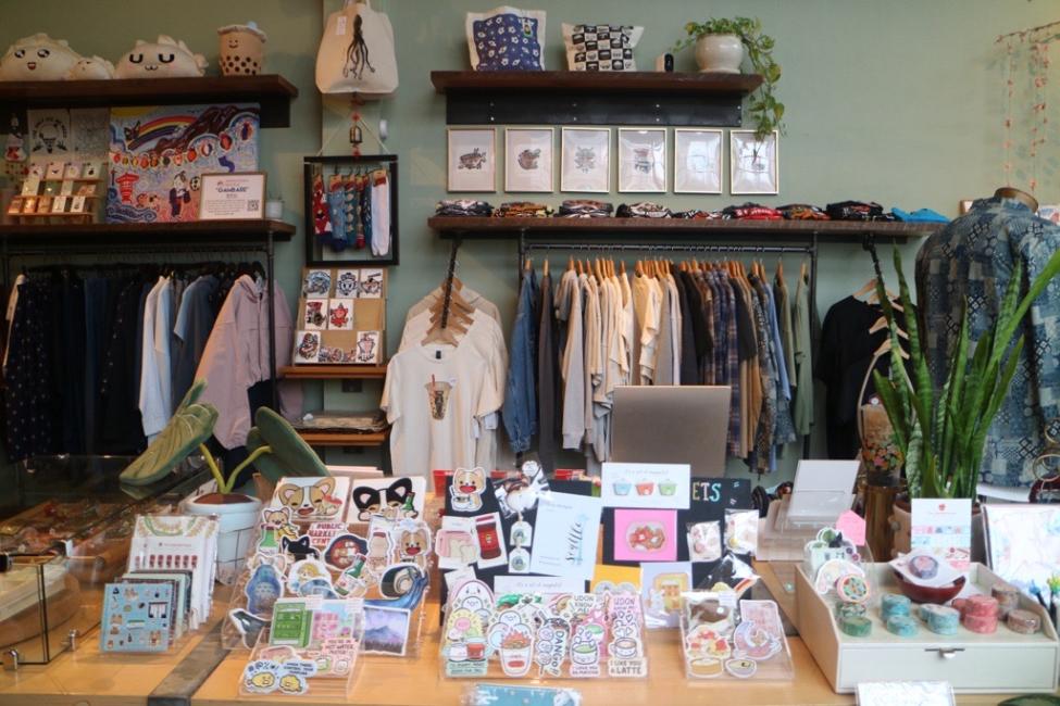 Items are displayed on a table and on shelves in a store