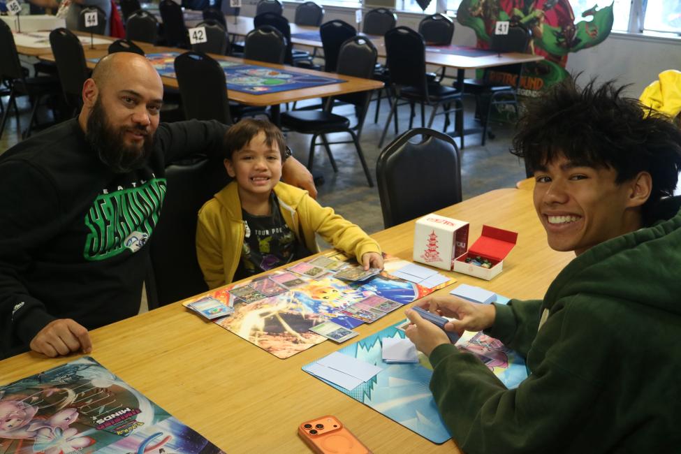 Two people play a game while seated at a table