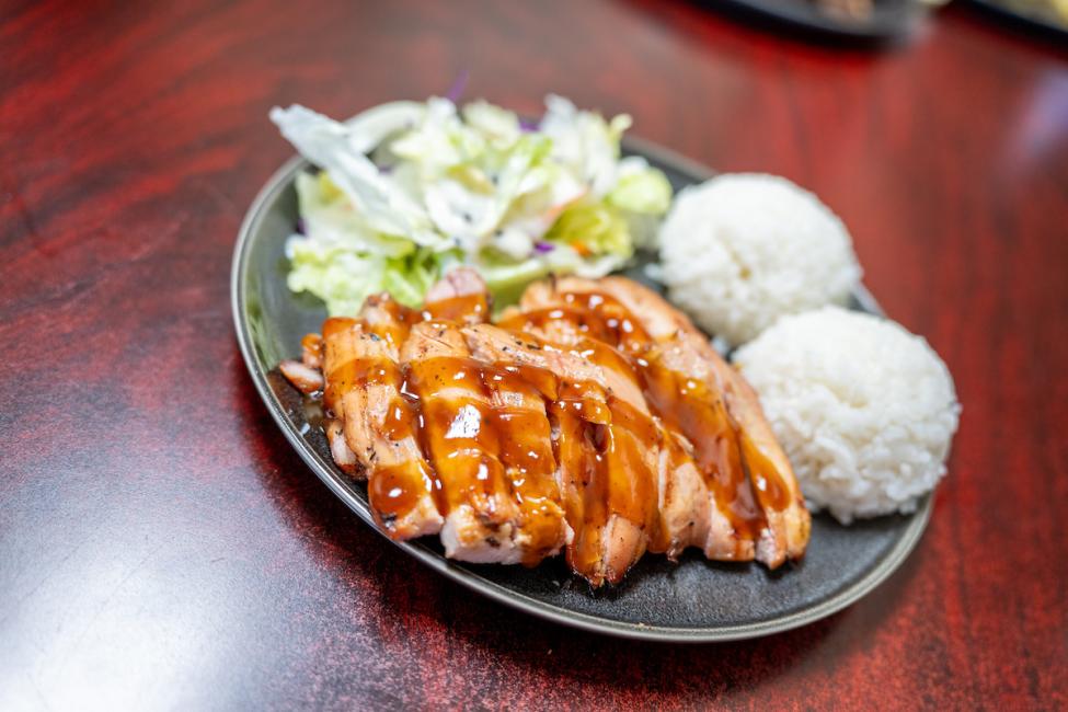 A plate of chicken teriyaki, rice, and salad