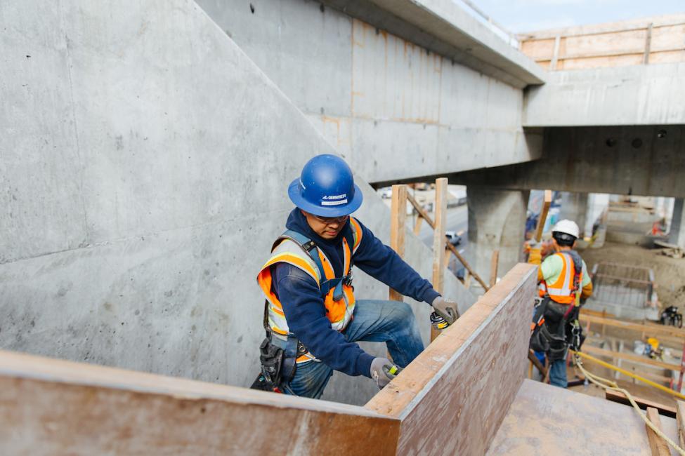 Workers build stairwells at the future Northgate Link light rail station